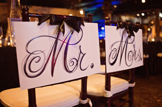 Mr and Mrs chair signs with black bows wedding day