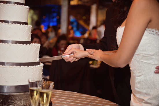 Newlyweds cut their beautiful layered wedding cake