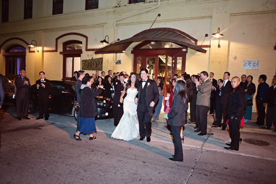 Bride and groom exit wedding to cheers and confetti