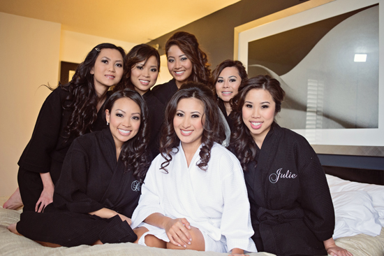 Bride and bridesmaids in robes getting ready for wedding