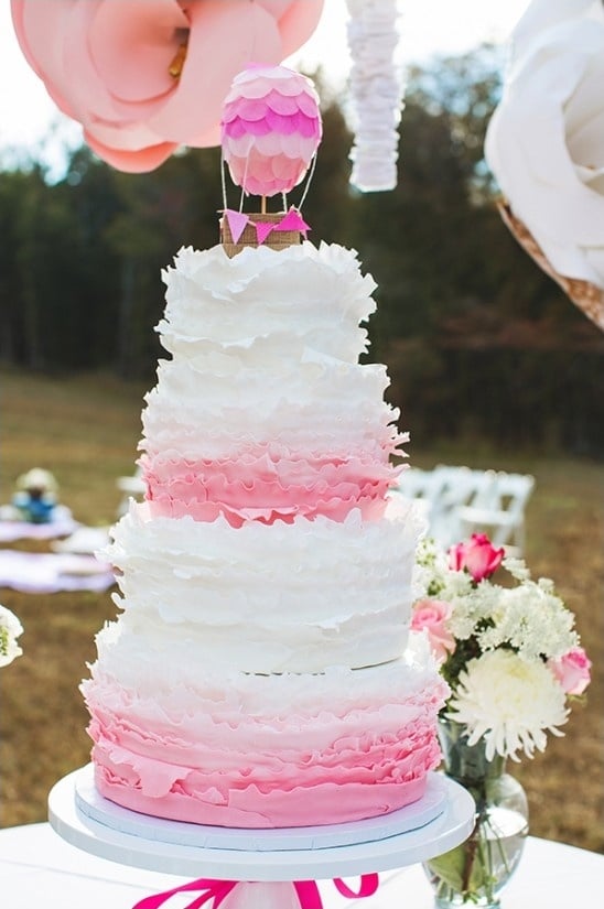 pink ruffle wedding cake with hot air balloon topper