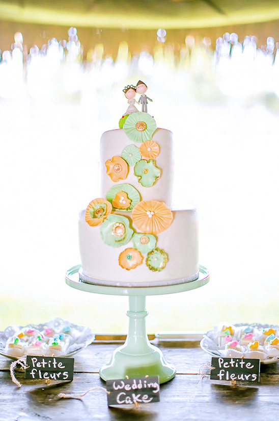 orange and mint wedding cake with custom topper