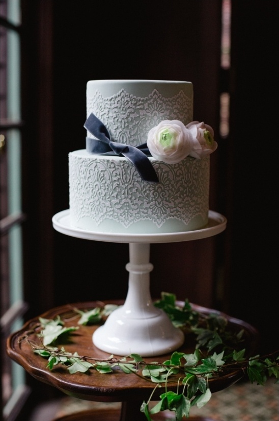 mint cake with delicate lace accents and tied with a velvet ribbon