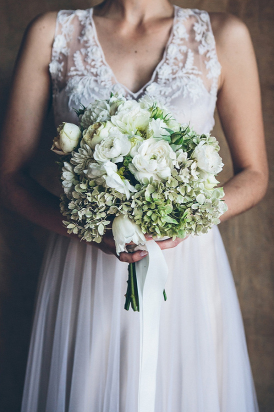 Bride with beautiful white and green floral bouquet