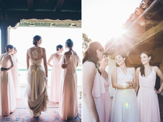 Joyful bridesmaids in pink gowns laugh with bride at outdoor wedding
