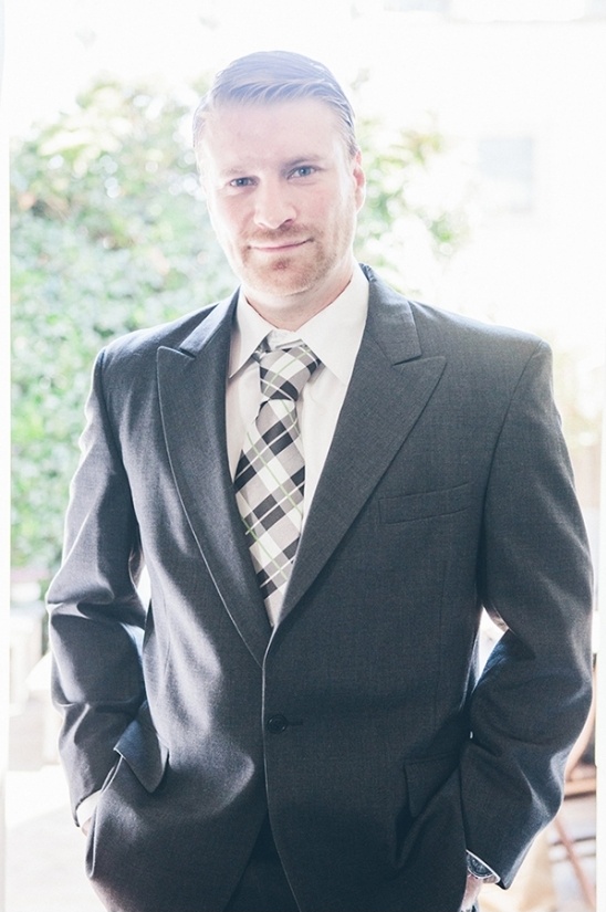 Smiling businessman in grey suit and patterned tie
