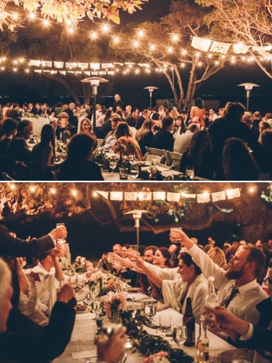 Outdoor wedding reception dinner under string lights