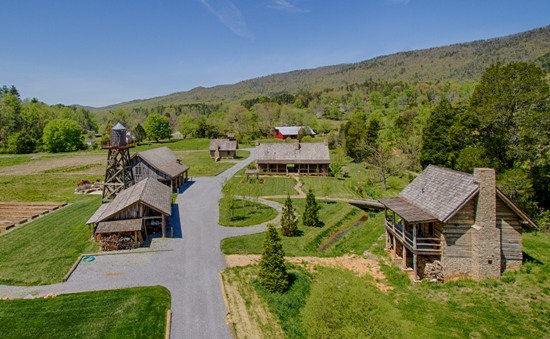 Scenic view of rustic farmhouses in green valley
