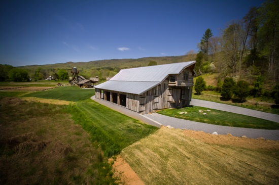 Rustic barn with metal roof in a green countryside