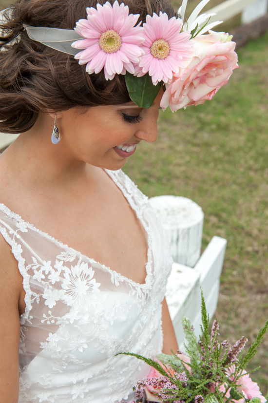Bride with flower crown and lace wedding dress smiling