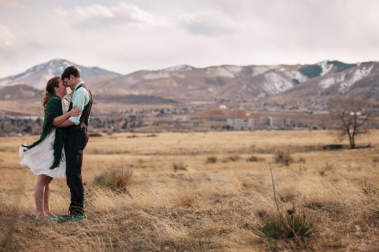 Loving couple embracing mountain backdrop outdoors
