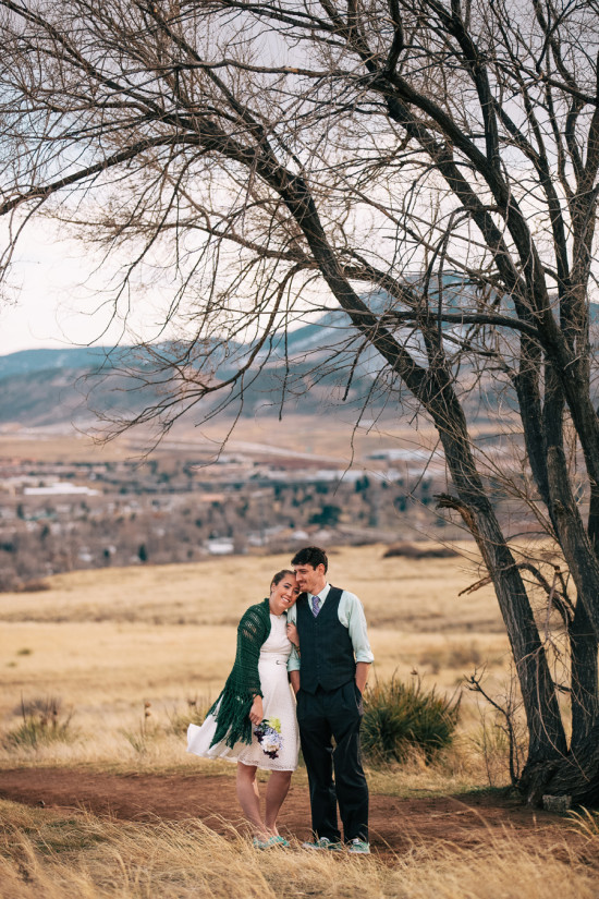 Romantic couple embracing under tree mountain landscape