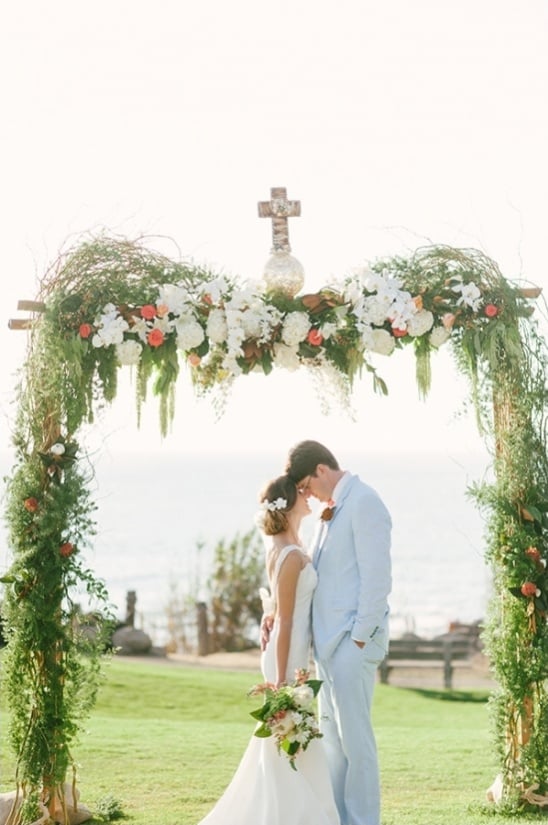 floral and vine covered wedding ceremony arch
