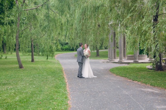 Happy couple embracing on a park path near a gazebo