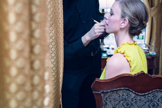 Woman getting makeup applied by artist