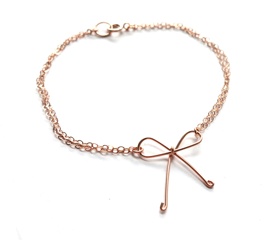 Rose gold chain bracelet with a delicate wire bow charm