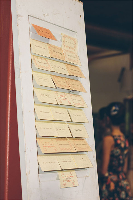 escort cards hanging on old door