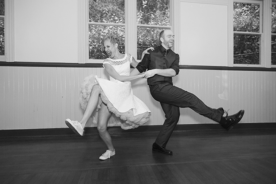 Happy couple swing dancing in vintage attire