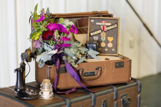 Vintage suitcase with flowers and antique telephone