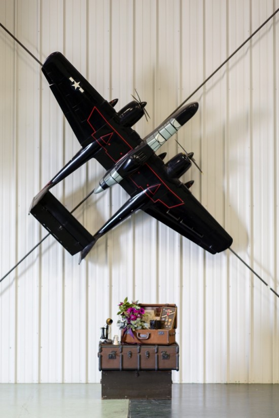Vintage airplane decor above stacked steamer trunks