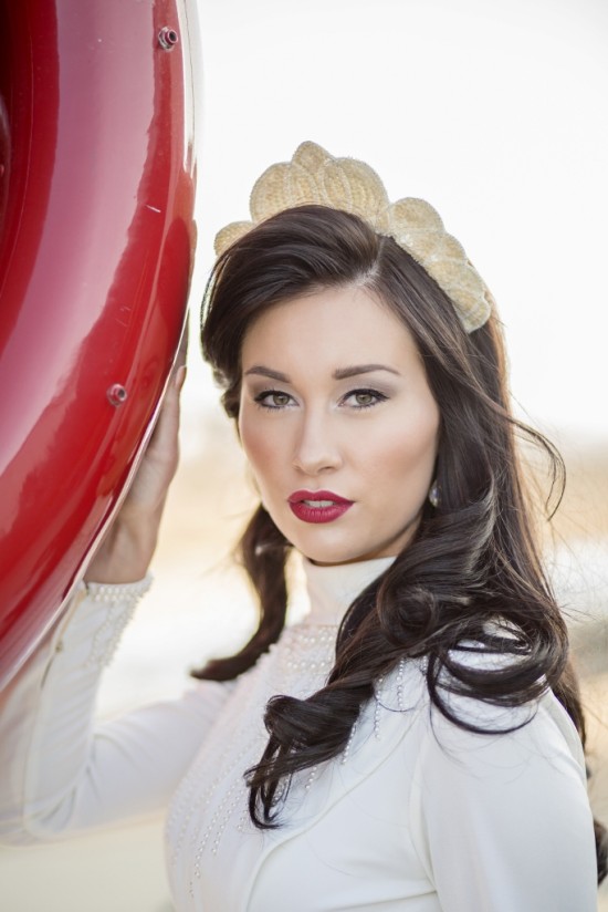 Woman with red lipstick and a gold crown headpiece