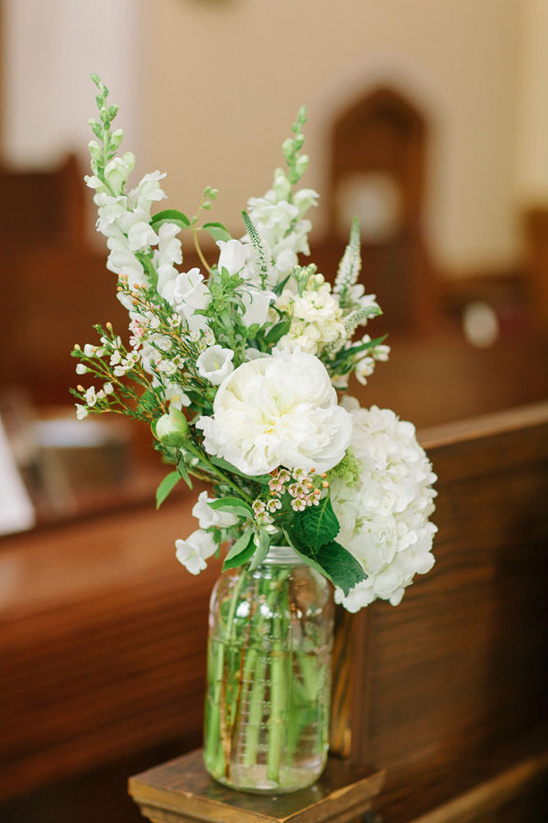 white mason jar flower arrangements for aisle decor