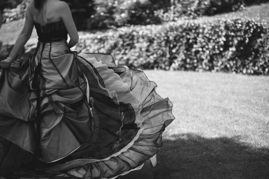 Elegant woman in a flowing black and white dress in a garden