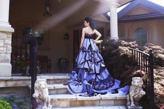 Woman in a blue dress on a porch with lion statues