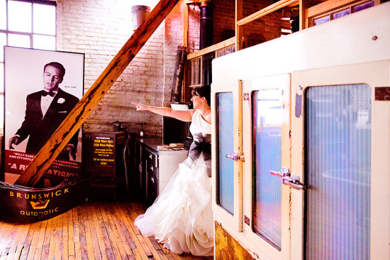 Bride in wedding dress pointing towards a glass door