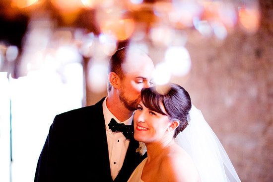 Groom kisses bride at wedding ceremony, romantic moment captured