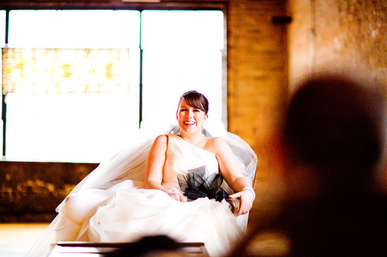 Smiling bride sitting in a chair on her wedding day looking happy