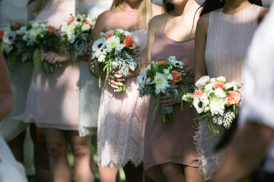 Bridesmaids holding bouquets at a wedding in pastel dresses