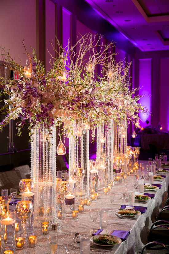 Elegant wedding table setting with flower and candle centerpieces