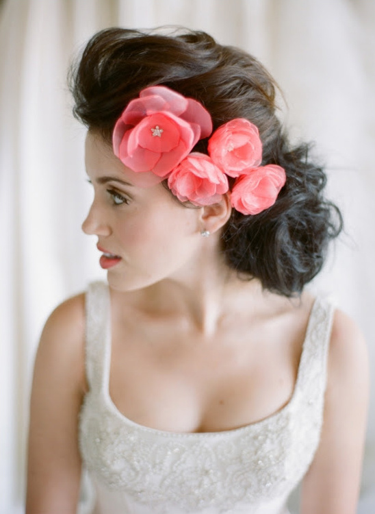 Bridal hair with pink flower adornment and gown