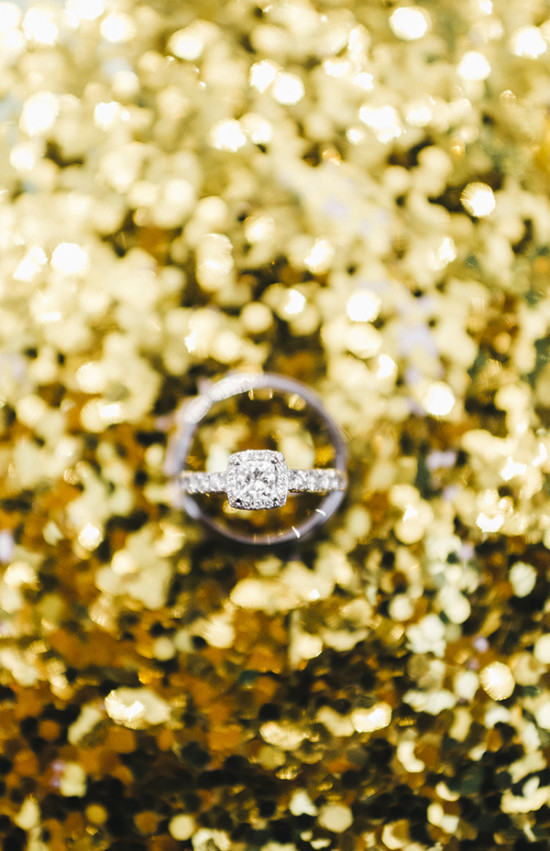 Elegant diamond engagement ring on sparkling gold glitter
