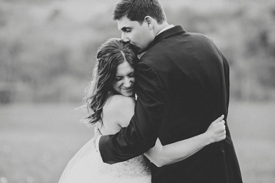 Newlyweds share a tender embrace on their wedding day