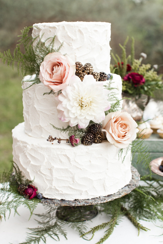 white wedding cake with gold dusted berries