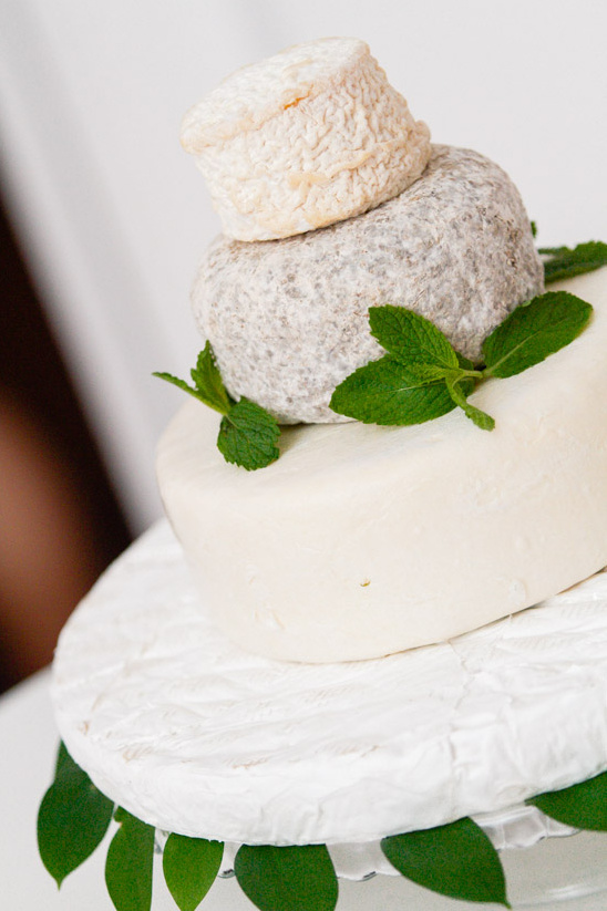 A beautiful cheese wedding cake decorated with fresh mint and leaves