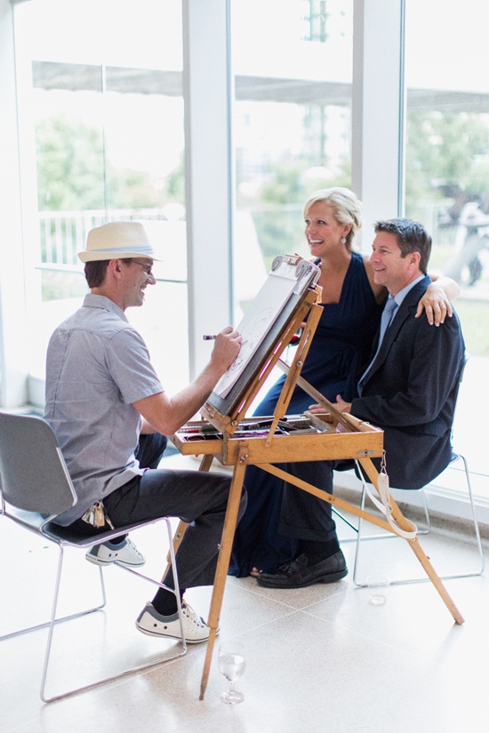 Artist drawing a portrait of a smiling couple at a party