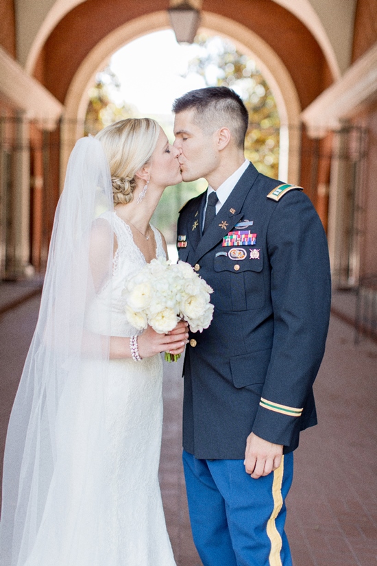Bride and groom kiss in a loving moment on their wedding day