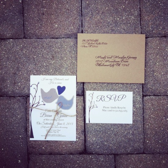 Wedding invitation with lovebirds and RSVP card on a brick surface
