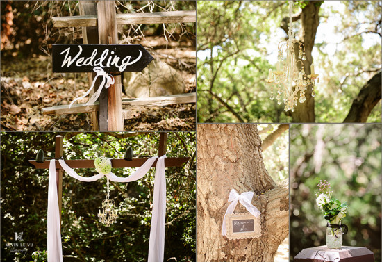 Outdoor wedding decor with signage and chandelier in the trees