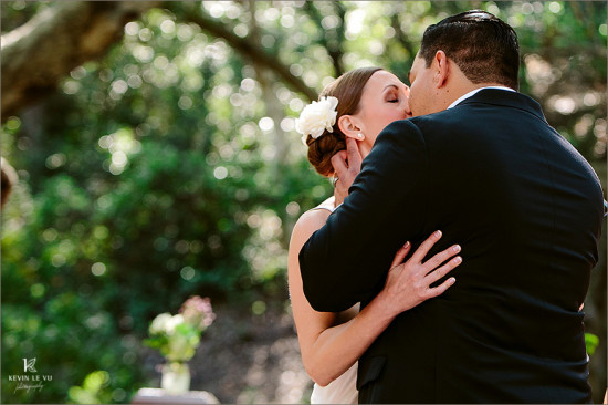 Newlyweds share a passionate kiss on their wedding day