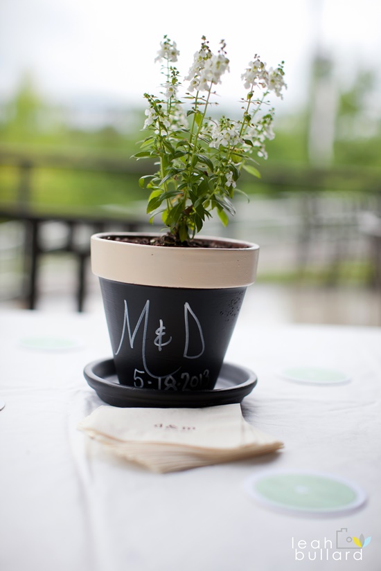 A charming wedding centerpiece with a potted plant and initials
