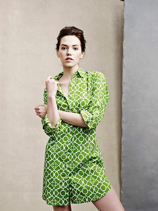 Woman in a stylish green dress with white geometric pattern