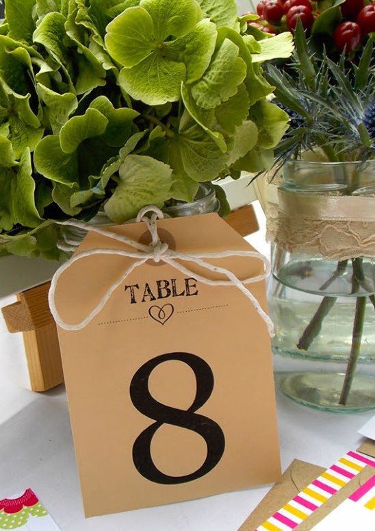 Table number eight with fresh flowers in a rustic wedding decor