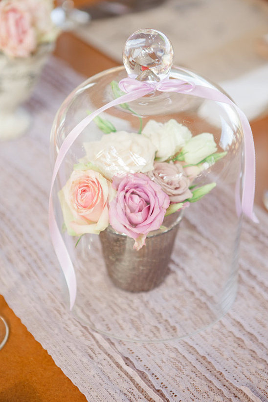 rose arrangement under glass