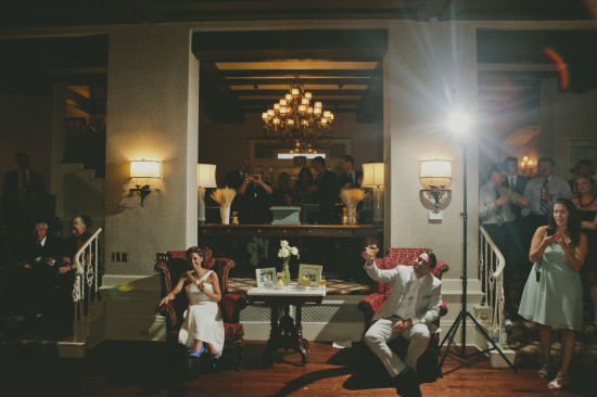 Bride and groom toast at a wedding reception in a vintage room