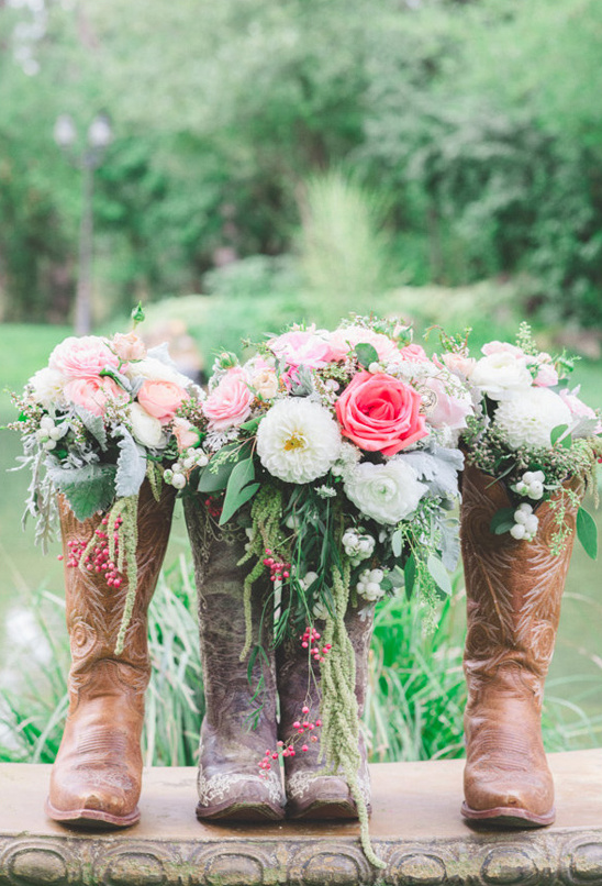 Cowboy boots filled with floral wedding bouquet decor