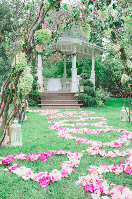 Garden wedding venue with gazebo and flower petals